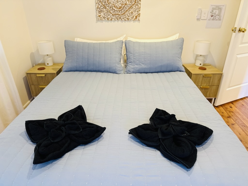 Freshly-made king bed with dressed pillows